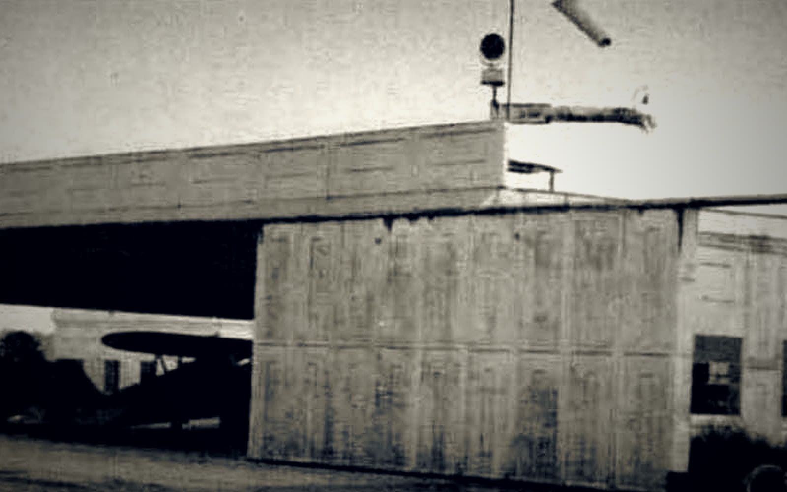 Historic R.G. LeTourneau hangar at Toccoa-Stephens County Airport, with an aircraft visible in the open bay.